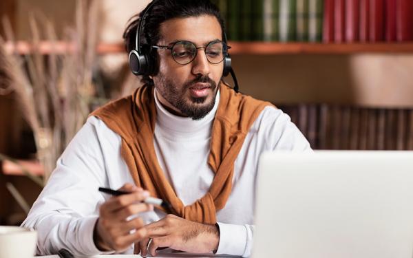 an African American man watching a webinar